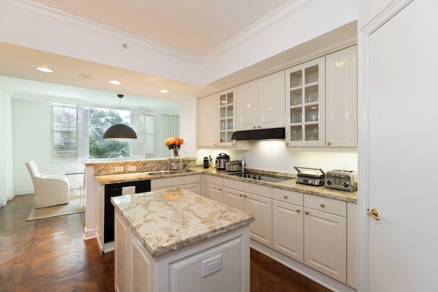 kitchen with sink, white cabinets, hanging light fixtures, black cooktop, and dark parquet flooring