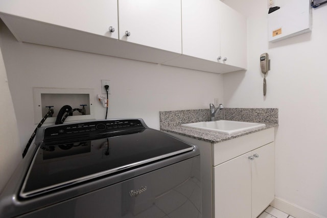 laundry room featuring light tile patterned floors, sink, washer / dryer, and cabinets