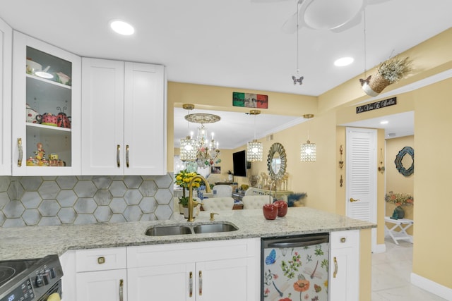 kitchen featuring dishwasher, electric range, and white cabinets