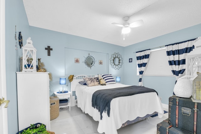 bedroom with a textured ceiling and ceiling fan