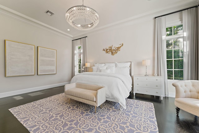 bedroom with dark hardwood / wood-style flooring, crown molding, and a chandelier