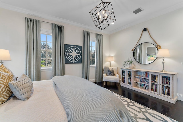 bedroom with a notable chandelier, ornamental molding, hardwood / wood-style floors, and multiple windows