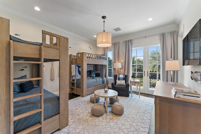 bedroom with ornamental molding and french doors