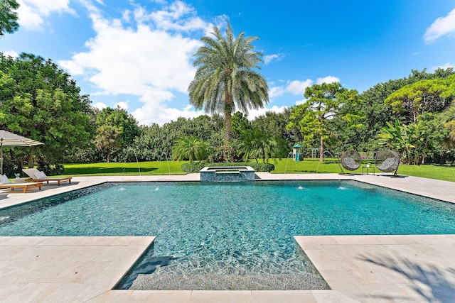 view of pool featuring an in ground hot tub, a lawn, and a patio