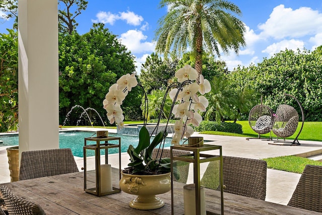 view of swimming pool featuring pool water feature and a patio