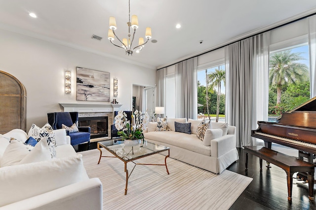 living room with hardwood / wood-style flooring, a chandelier, and ornamental molding