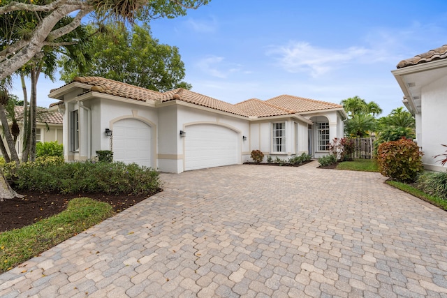 mediterranean / spanish-style house featuring a garage