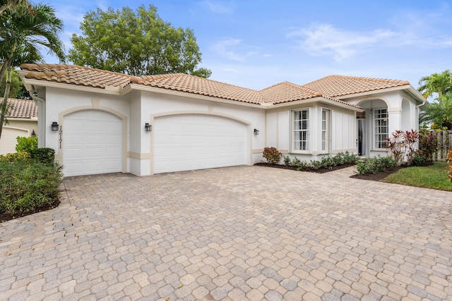 mediterranean / spanish-style house featuring a garage