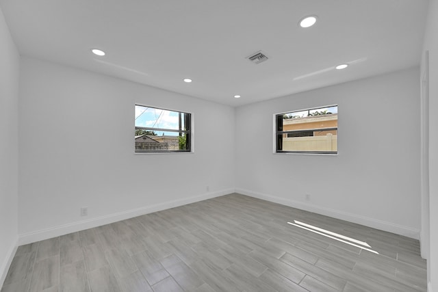 spare room with light hardwood / wood-style flooring