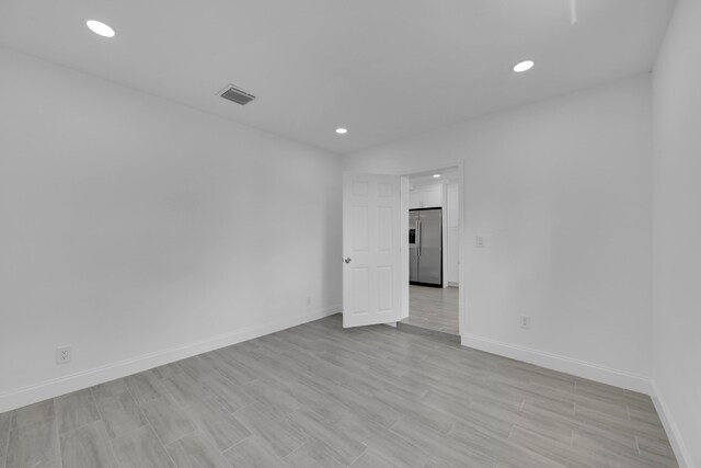 unfurnished room featuring light hardwood / wood-style floors