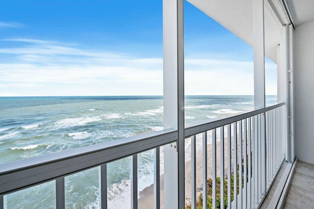 exterior space featuring a water view and a view of the beach