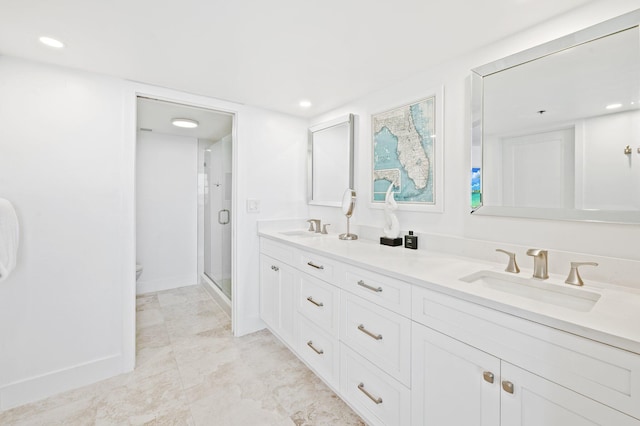 bathroom featuring vanity, a shower with shower door, and toilet