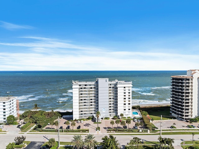 birds eye view of property featuring a water view and a beach view