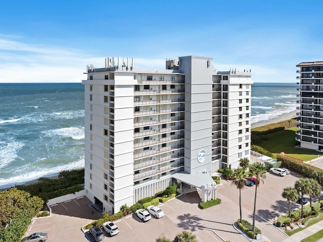 view of property featuring a water view and a beach view