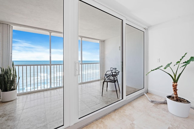 entryway with a water view and a wall of windows