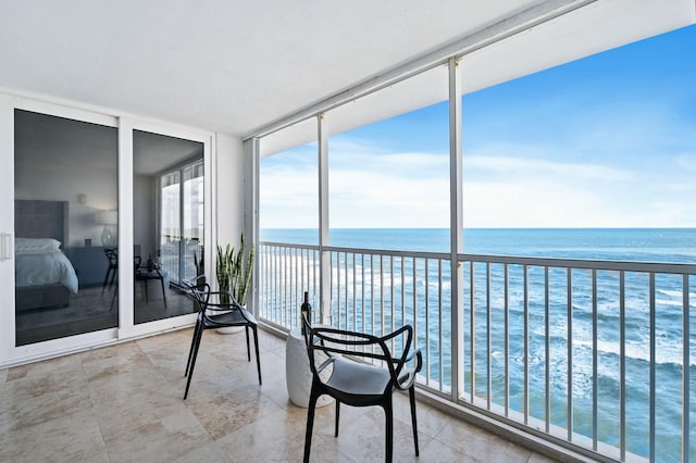 sunroom / solarium with a water view