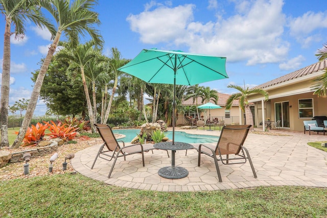 view of pool with a fire pit, a yard, a patio, and pool water feature