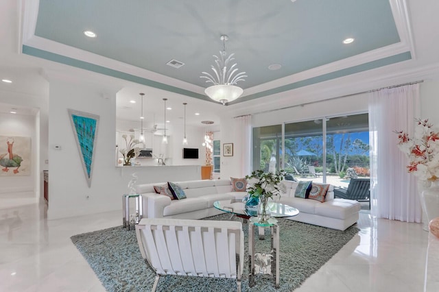 dining area with a raised ceiling, ornamental molding, and an inviting chandelier