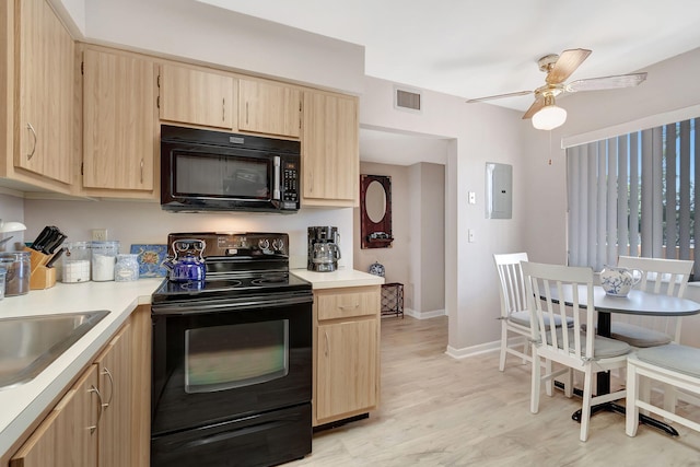 kitchen with light brown cabinetry, light wood-type flooring, electric panel, ceiling fan, and black appliances