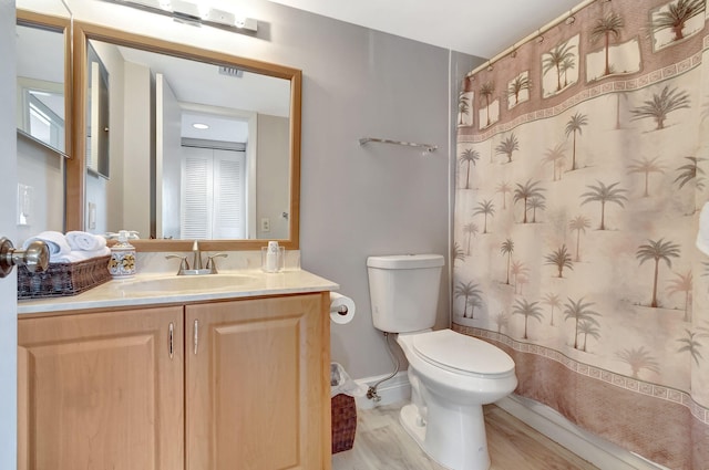 bathroom featuring vanity, wood-type flooring, toilet, and a shower with shower curtain