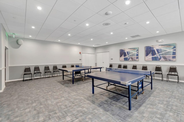 playroom with a paneled ceiling and carpet