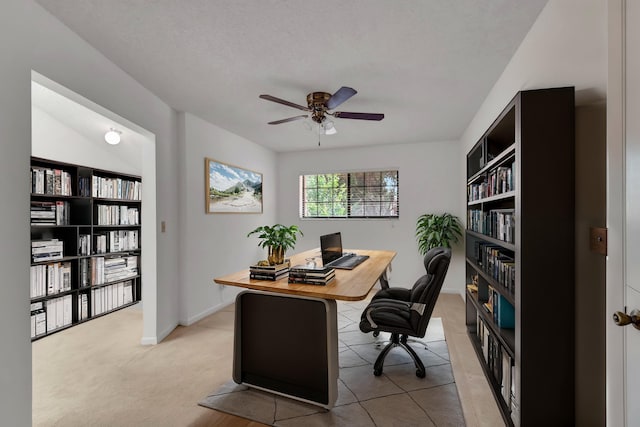 office area featuring a textured ceiling, ceiling fan, and light colored carpet