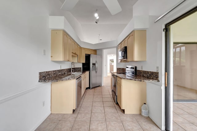 kitchen with light tile patterned floors, stainless steel appliances, plenty of natural light, and sink