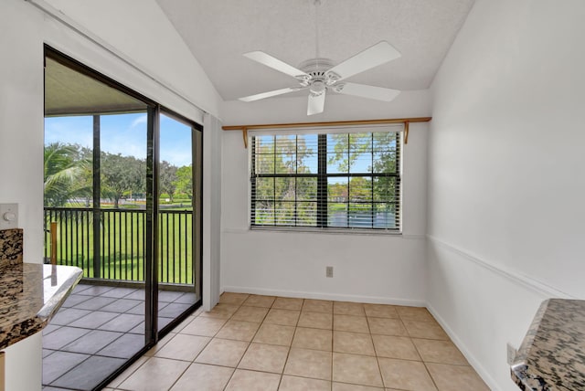 unfurnished sunroom with lofted ceiling and ceiling fan