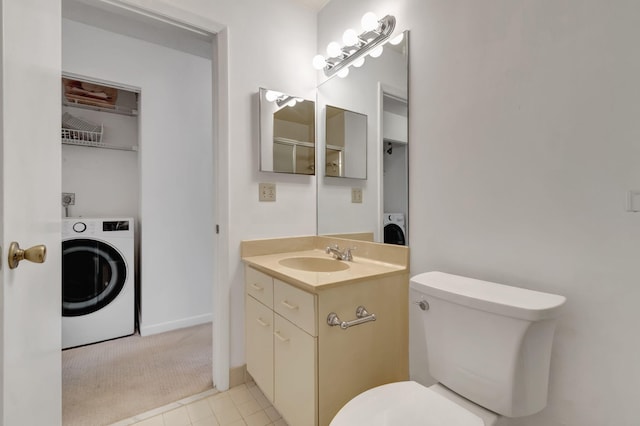 bathroom with tile patterned flooring, washer / clothes dryer, and toilet