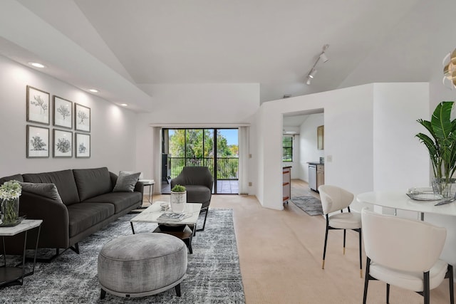 living room with carpet flooring and vaulted ceiling