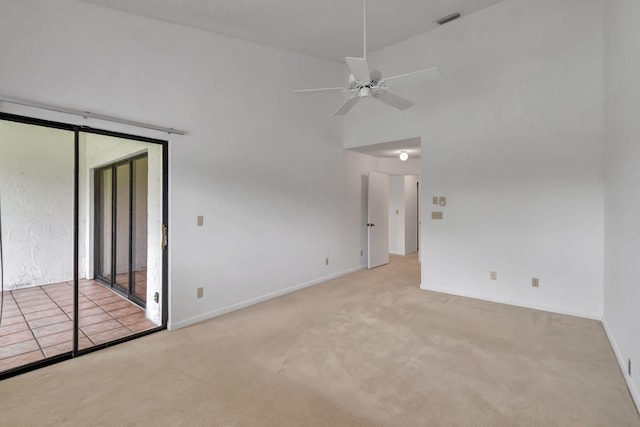 spare room with ceiling fan and light colored carpet