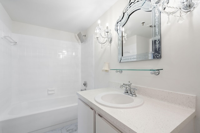 bathroom with vanity and tiled shower / bath