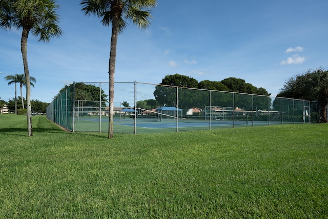 view of sport court featuring a yard