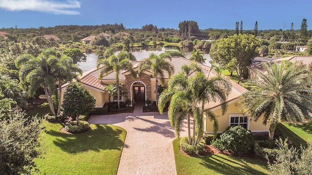 exterior space featuring a water view and a front lawn