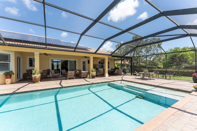 view of swimming pool with a lanai, a patio, ceiling fan, and outdoor lounge area