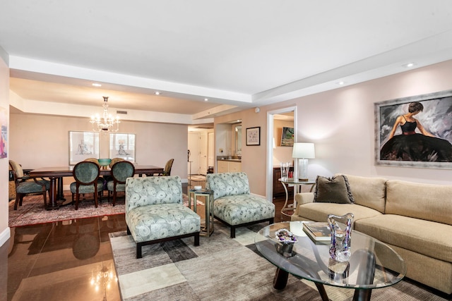 living room with a raised ceiling and a notable chandelier