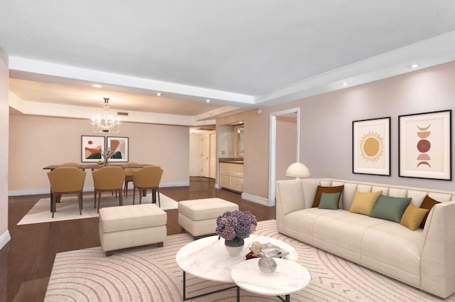 living room featuring a chandelier, hardwood / wood-style floors, and a raised ceiling