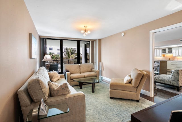 living room with floor to ceiling windows and a notable chandelier