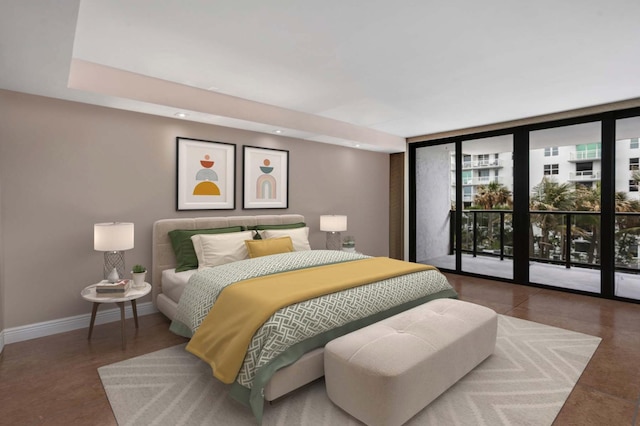 bedroom featuring a wall of windows, baseboards, access to outside, and recessed lighting