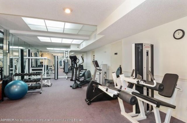 exercise room with a textured ceiling