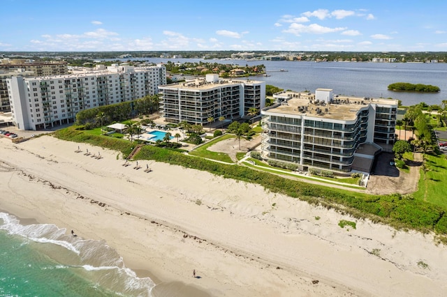 bird's eye view featuring a water view and a beach view