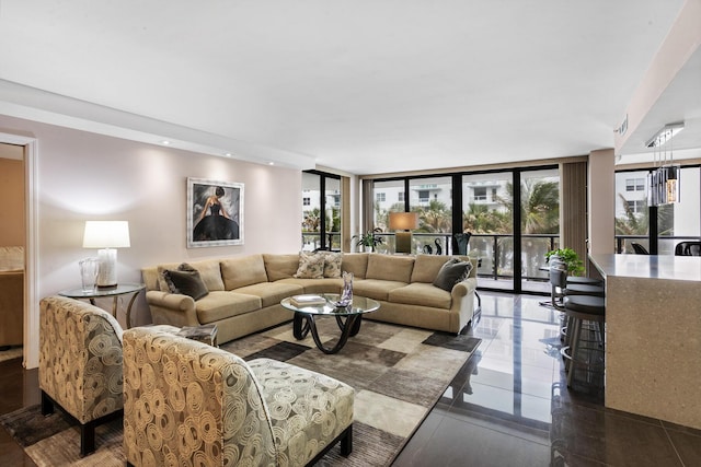 living area with recessed lighting and a wall of windows