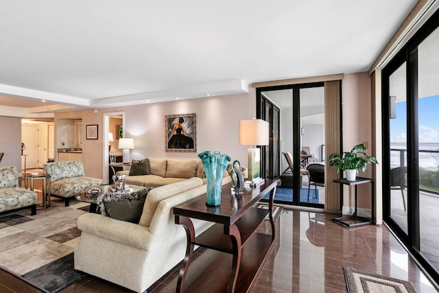 living room featuring floor to ceiling windows and french doors