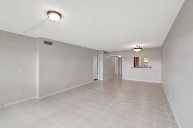 spare room featuring light tile patterned flooring