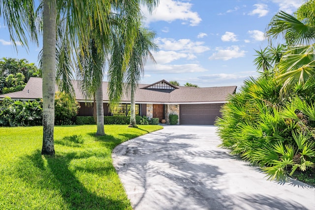 single story home featuring a front lawn and a garage