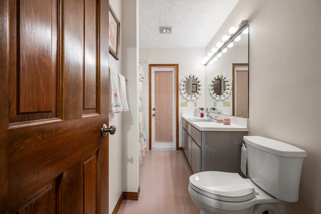 bathroom featuring vanity, a textured ceiling, tile patterned flooring, toilet, and a shower with curtain