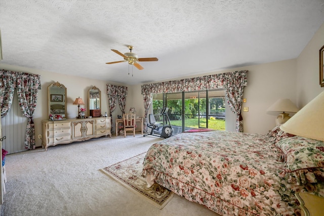 carpeted bedroom with ceiling fan, a textured ceiling, and access to exterior