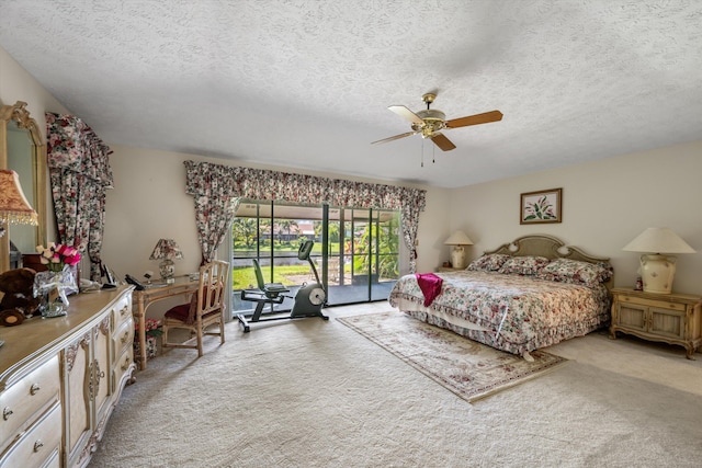 bedroom featuring access to outside, carpet floors, a textured ceiling, and ceiling fan