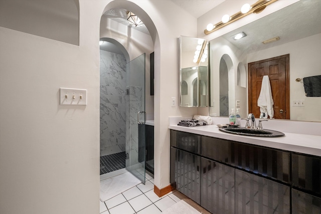 bathroom with vanity and a shower with shower door