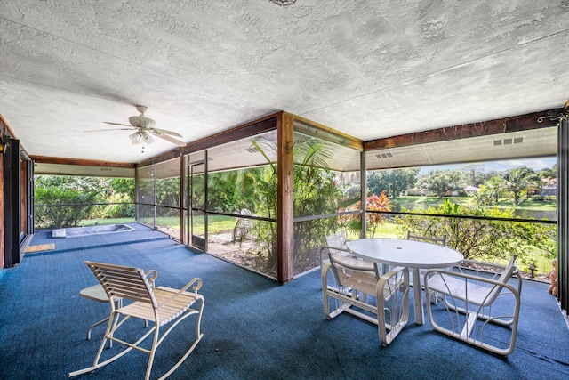 sunroom featuring ceiling fan